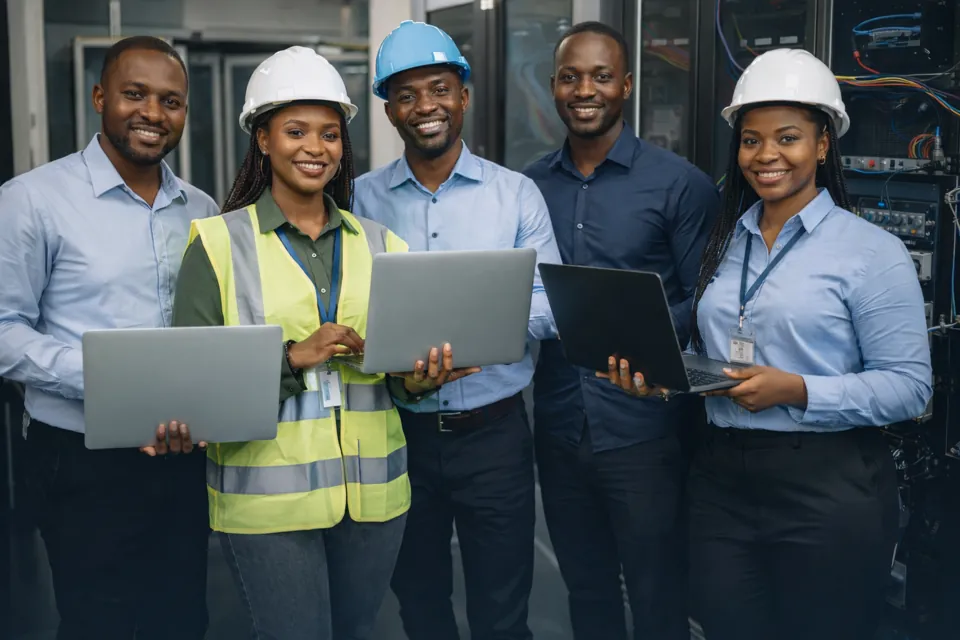 Engineers reviewing ICT equipment in a server environment
